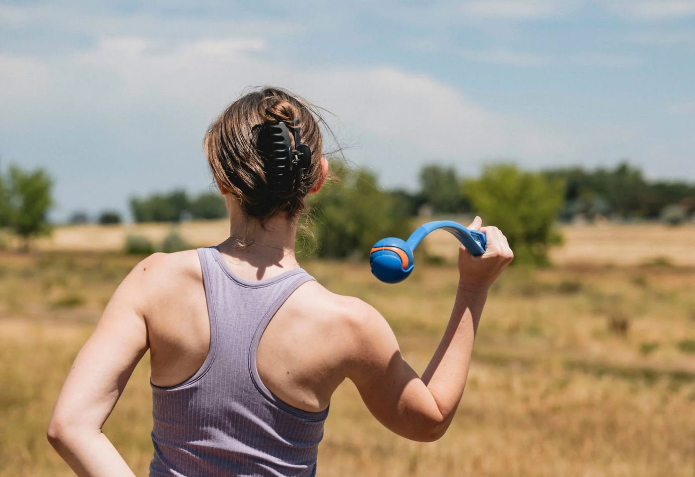 Girl playing fetch with a rubber ball