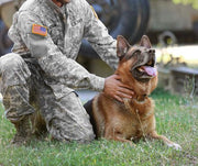 Image of U.S. Service Member With Their K9 German Shepard In Grassy Field 