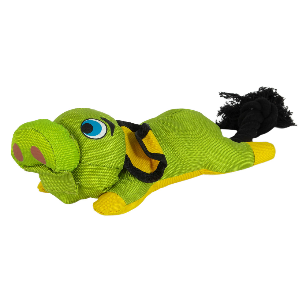 The Hyperpet Flying Pig Interactive Dog Toy is a vibrant green and yellow plush resembling a cartoon alligator with bulging eyes, a snout, black rope tail, and accents. Made of durable ballistic material, it is designed for slingshot-style pet play.