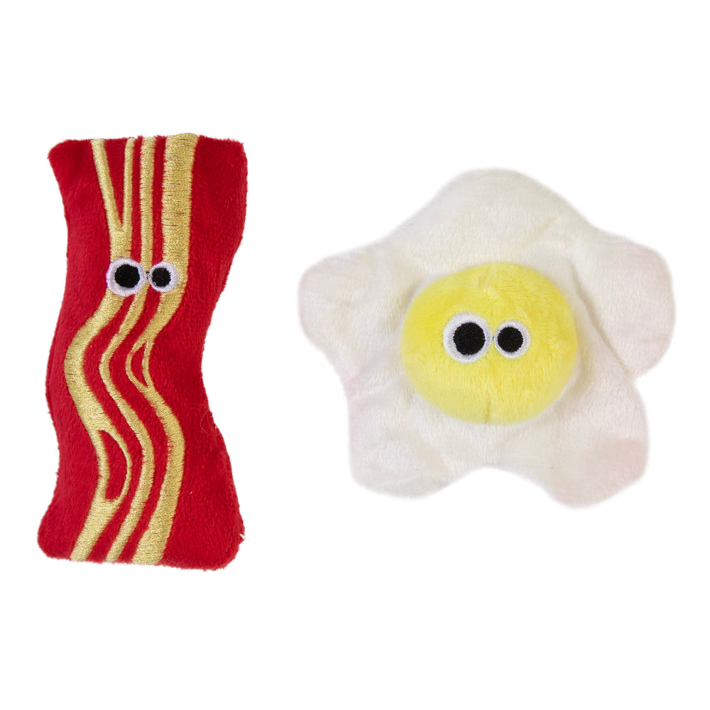 The Mad Cat Brunch Buddies Bacon N Eggs Catnip & Silvervine Cat Toy features plush toys shaped like bacon and a sunny-side-up egg with small round eyes. The bacon is red with yellow stripes, and the egg has a sunny yellow center with white edges, making them irresistible for cats.