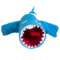 The Mad Cat Jumpin Jaws Shark 38 Tunnel is a blue fabric play tunnel designed like a shark with large eyes, a red mouth interior, and sharp white teeth. It includes side fins and a top tail fin, creating an open-mouth entrance ideal for interactive fun and agility training.