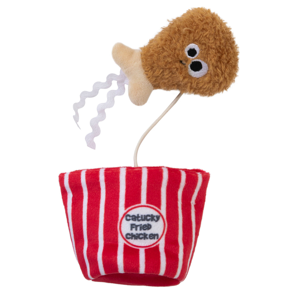 The Mad Cat Catucky Fried Chicken toy has a plush fried chicken drumstick with wavy legs attached to a bucket labeled Catucky Fried Chicken and infused with North American catnip, providing endless entertainment for cats.