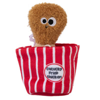 The Mad Cat Catucky Fried Chicken is a stuffed toy shaped like a fried chicken drumstick with googly eyes, nestled in a red and white striped box. It features North American catnip and has a light brown fuzzy finish with a bow, making it an irresistible cat puzzle toy.