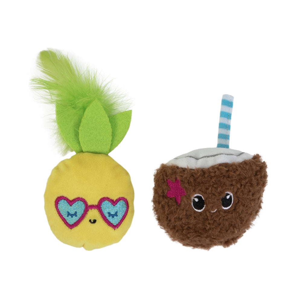 On the left is a yellow fruit plush with green felt leaves, heart-shaped eyes, and a smile; on the right is Quirky Kittys Purrfect Pina Colada catnip toy, shaped like a fuzzy brown coconut with a smiley face, blue-striped straw, and magenta star.