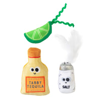 The Mad Cat Tabby Tequila 3 pack features catnip-infused toys shaped like a lime wedge, tequila bottle, and salt shaker, each with cartoon eyes and smiles. A feather tops the salt shaker for endless feline fun.