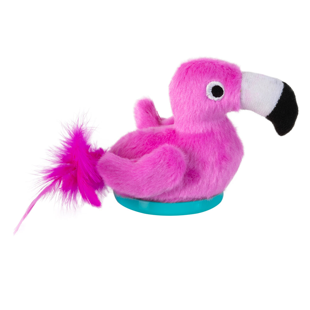 Introducing the Mad Cat Sassy Scoocher Flamingo, a pink plush toy with a black and white beak, fluffy tail, and blue base. Its round white eyes with black pupils make it ideal for playtime. Infused with catnip and silvervine, its sure to delight your pet!.