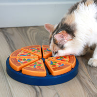 A cat is using the Quirky Kitty Pizza Puzzle by Quirky Kitty on the wooden floor. This innovative toy has detachable triangular slices with colorful toppings, providing both slow feeding and interactive mental exercise.