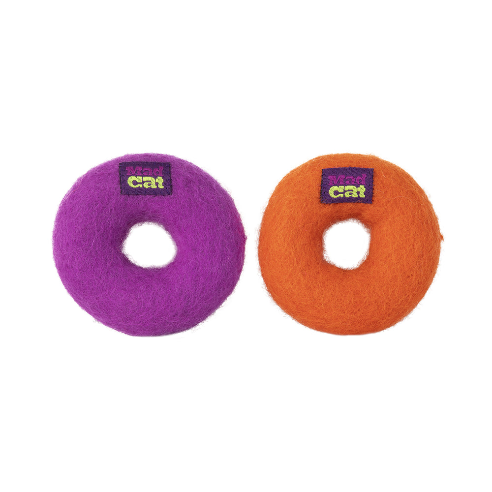 Two Mad Cat Wacky Wool Rings, one purple and one orange, each featuring a Mad Cat label. Made from natural wool, these soft toys have a hole in the center resembling small donuts, displayed on a plain white background.