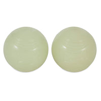 Two translucent, pale green round objects with a smooth surface are side by side against a white background. They resemble the durable rubber Chuckit! Max Glow Fetch Ball by Chuckit, appearing similar in size and texture.