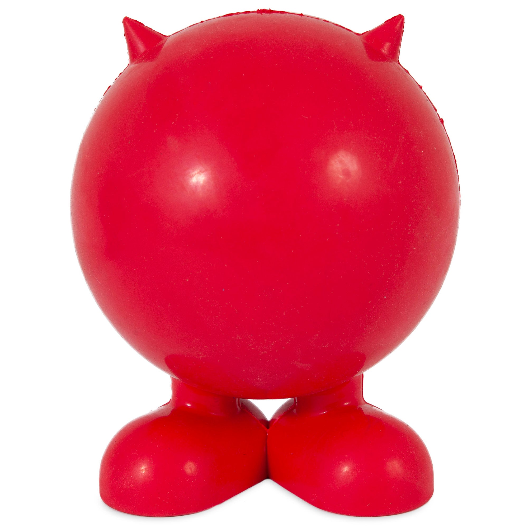 The JW Cuz Dog Toy by Jw is a round, glossy red figure with short horns and large, shoe-like feet. Its a sturdy dog toy made of natural rubber, designed without facial features or arms, known for its resilience and unique charm.