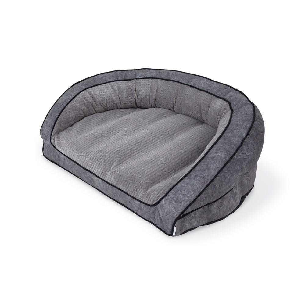 The La-Z-Boy Harper Smoke Sofa for dogs boasts a gray, oval design with a plush interior. It features raised back and sides with black piping, a charming checkered pattern, Comfort Select fiber-fill for comfort, and has a machine washable cover for easy care.