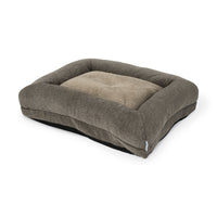 The La-Z-Boy Rosie Lounger Taupe is a rectangular, plush dog bed with raised edges and a soft, textured surface in shades of gray and beige. It features a thick cushion and has the La-Z-Boy label on one side.