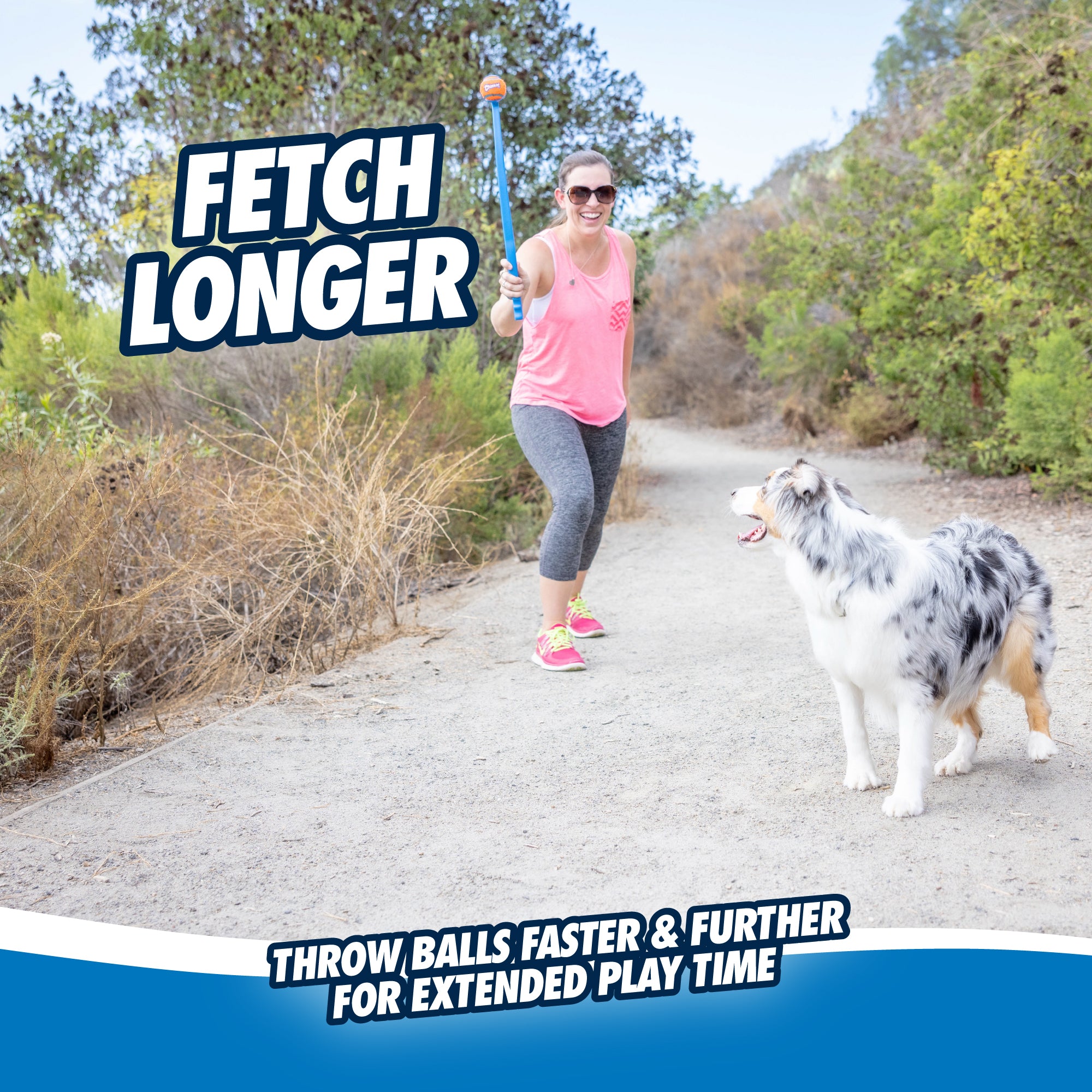 A woman in a pink tank top and gray leggings uses the Chuckit! Sport Launcher with an ergonomic rubber handle to play fetch with an Australian Shepherd on a dirt path. Text reads FETCH LONGER and Throw balls faster & further for extended play time.