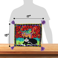 The FAT CAT Boogie Catnip Cat Mat by Fatcat is a vibrant, colorful pillow displaying a playful cat and red flowers. It measures 17x13, features purple tassels at each corner, and is designed as a refillable catnip mat. The mat rests on wood with a grey silhouette in the background.