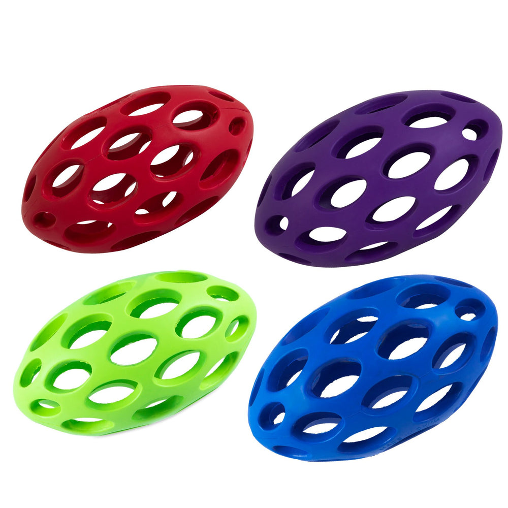 Four JW Hol-ee Football Dog Toys by Jw, featuring a durable lattice design with multiple treat holes, are displayed against a white background. The oval-shaped toys come in red, purple, green, and blue.